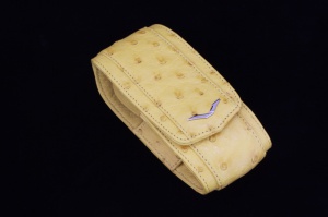 Closed case yellow ostrich leather with a logo in the shape of the letter V made of stainless steel